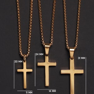May include: Three gold chain necklaces with cross pendants of different sizes. The smallest cross is 1.1 inches wide and 2 inches long. The middle cross is 1.4 inches wide and 2.4 inches long. The largest cross is 1.6 inches wide and 3.1 inches long.