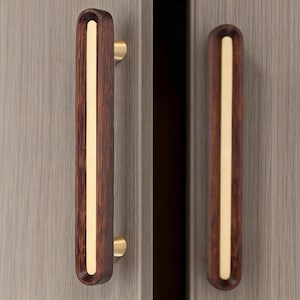 May include: A white ceramic mug with a black handle and the text "But First, Coffee" in a black, bold font. The mug is sitting on a wooden surface.