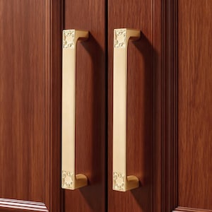 May include: A white ceramic mug with a black handle and the text "But First, Coffee" in a bold, black font. The mug is set against a blurred background, suggesting a cosy setting.