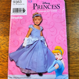 May include: Simplicity Disney Princess costume pattern for a child. The pattern shows a young girl in a light blue Cinderella dress with white gloves and a headband. The package has the Disney Princess logo and the word "Princess" in large letters.