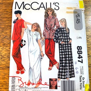 May include: McCall's sewing pattern envelope with sleepwear designs. The envelope shows a red pajama set, a white nightgown, a red and white striped pajama set, and a black and white plaid nightgown. The pattern is for an extra small size.