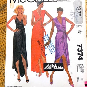 May include: A sewing pattern for three different wrap dresses. The dresses are shown in black, orange, and purple. The pattern number is 7374 and the size is 6, bust 30 1/4 inches.
