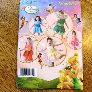 May include: A Simplicity sewing pattern featuring Disney fairies. The pattern includes images of Tinker Bell, Silvermist, Rosetta, and Iridessa. The pattern number is 2559, and the size is A 1/2, 1, 2, 3, 4.