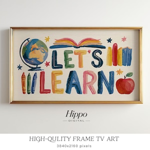 May include: A rectangular digital art print in a gold frame featuring the text LET'S LEARN in colourful, textured letters. The design includes a globe, an open book, three crayons, a row of books, and a red apple on a cream background.