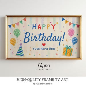May include: A digital TV art display in a gold frame featuring a crayon-style birthday illustration. The text reads HAPPY Birthday! and YOUR NAME HERE. It includes colorful balloons, a party hat, a gift box, and bunting on a striped background.