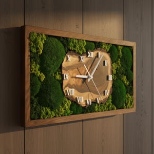 May include: A rectangular wall clock featuring a natural wood slice centre with white Roman numerals and thin white hands. The clock is surrounded by vibrant green preserved moss within a dark brown wooden frame, creating a textured display.