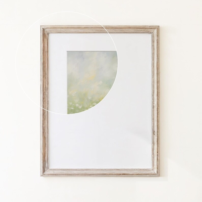 May include: A rectangular picture frame with a weathered light brown wood finish and a white mat board. A circular overlay highlights a portion of an abstract painting featuring soft, blended shades of pale green, yellow, and white tones.