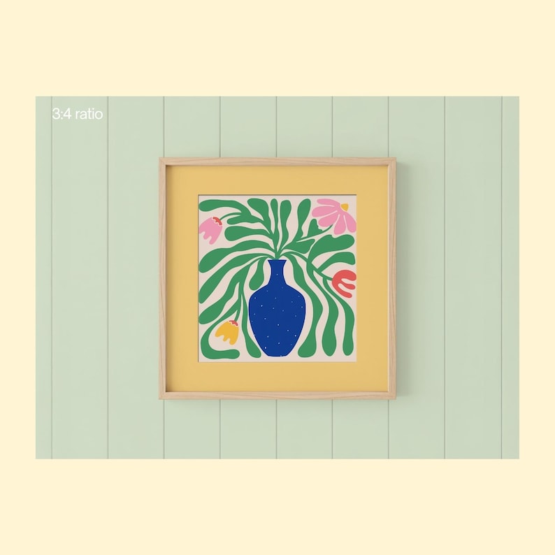 May include: A framed art print featuring a blue vase filled with green leaves and pink, yellow, and red flowers. The artwork is set against a yellow background within a light wood frame. The background is a light green vertical panel.