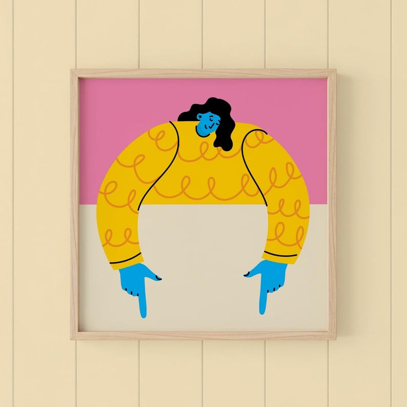 May include: A framed art print featuring a stylized illustration of a person with blue skin and black hair. The person is wearing a yellow sweater with a curly design and blue hands pointing down. The background is divided into pink and beige sections.