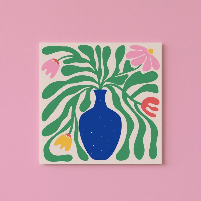May include: Square canvas art featuring a blue vase with green leaves and colorful flowers. The flowers are pink, yellow, and red. The background is off-white, and the surrounding wall is pink. The art has a modern, minimalist style.