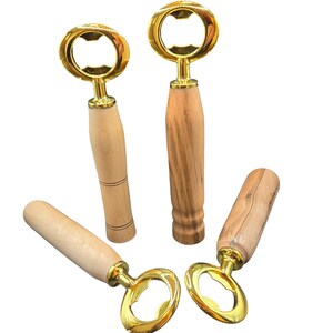 May include: Four bottle openers with gold-colored tops and wooden handles. The handles vary in wood grain and design. The bottle openers are arranged on a white background.