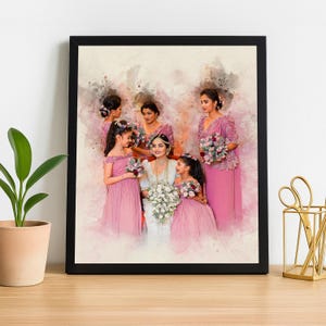 May include: A framed watercolour print depicting a bride in a white dress with bridesmaids and flower girls in pink dresses. The women hold flower bouquets, creating a soft, romantic aesthetic. The artwork is set against a neutral background.