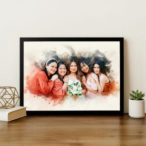 May include: A framed watercolour portrait of five people, in a black frame. The image has a soft, artistic feel with red and brown watercolour splashes. The subjects are smiling and embracing, holding a bouquet of white flowers.