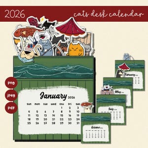 Pode incluir: Um calendário de secretária de 2026 com ilustrações de gatos. O calendário tem uma base verde com páginas mensais, incluindo janeiro, fevereiro, maio, julho e outubro. A parte superior do calendário tem ilustrações de gatos com um guarda-chuva vermelho.