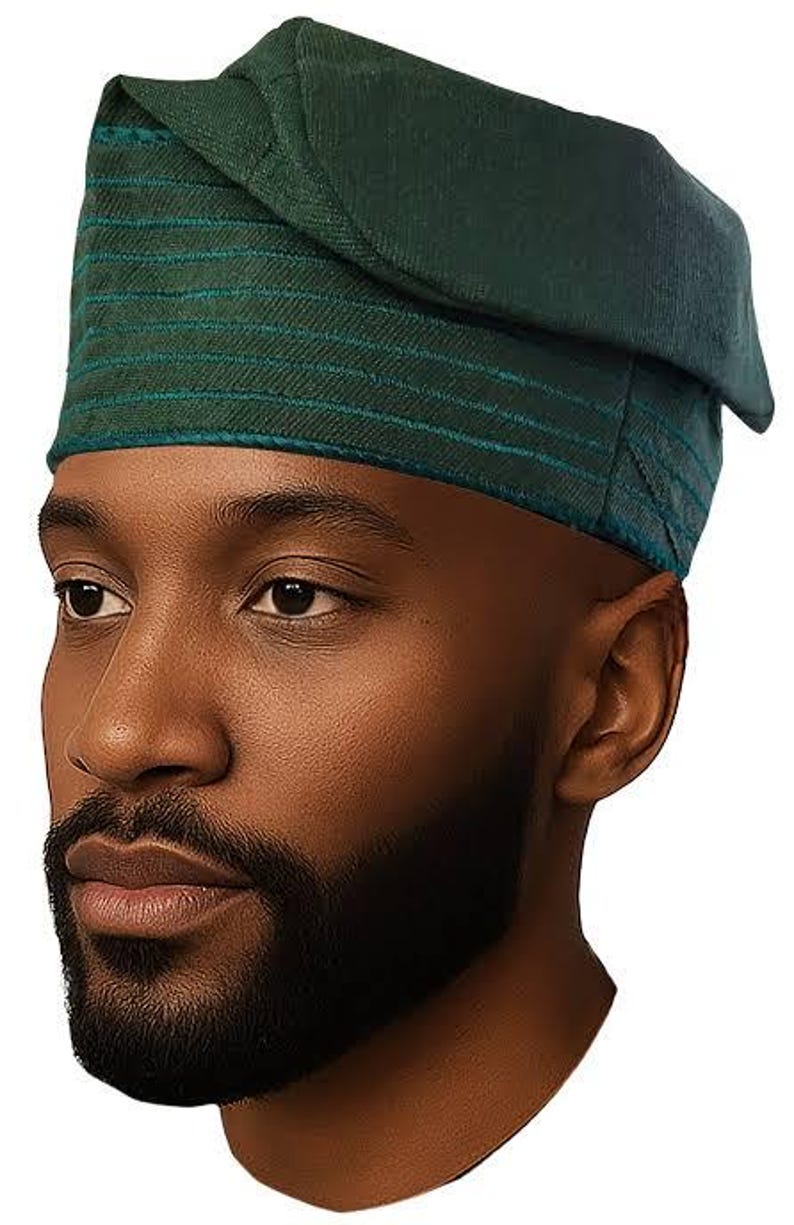 May include: A dark green head wrap with teal horizontal stripes. The head covering is folded over on the top and is worn on the head. The person in the image has a dark beard and skin.