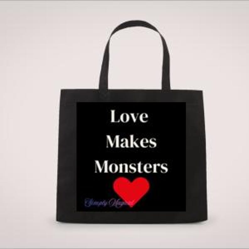 May include: Black tote bag featuring the text "Love Makes Monsters" in white, a red heart, and the words "Simply Magical" in blue script. The bag has two black handles.