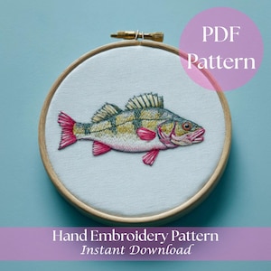 May include: Hand-stitched embroidery of a fish in a wooden hoop. The fish features yellow, green, and red details. The text "PDF Pattern" and "Hand Embroidery Pattern Instant Download" are visible.