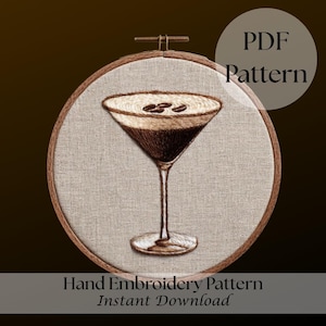 May include: Hand-stitched embroidery pattern of a brown cocktail with coffee beans in a martini glass, set in a wooden hoop. The image includes the text "PDF Pattern" and "Hand Embroidery Pattern Instant Download."