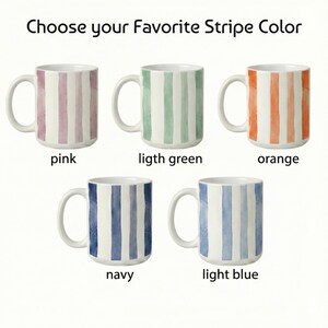 May include: White ceramic mugs with vertical stripes in pink, light green, orange, navy, and light blue. The text "Choose your Favorite Stripe Color" is at the top, with the color names below each mug.