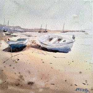 Può includere: Dipinto ad acquerello di due piccole barche bianche arenate su una spiaggia sabbiosa. Le barche sono in primo piano, con una costa nebbiosa e barche a vela in lontananza. Il dipinto ha una tavolozza di colori tenui e smorzati.