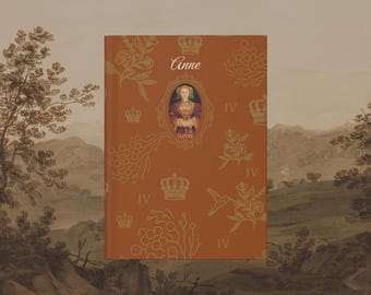 May include: A hardcover book with a rust-colored cover featuring gold floral patterns, crowns, and the name "Anne." The cover includes a portrait of a woman in a gold oval frame. The background shows a landscape painting.