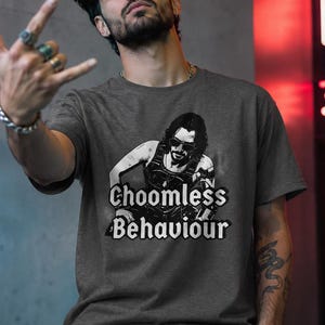 May include: Dark grey crew neck t-shirt with a black and white graphic of a person wearing sunglasses and the text "Choomless Behaviour".