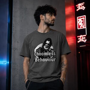 May include: Dark grey crew neck t-shirt with a black and white graphic of a person wearing sunglasses and the words "Choomless Behaviour".