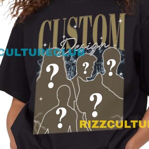 May include: Black t-shirt with the text "CUSTOM Design" in gold lettering. The shirt features a graphic of silhouettes with question marks. The text "RIZZCULTURECLUB" is printed on the shirt.