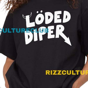 May include: Black t-shirt with the white text "LÖDED DIPER" and an arrow graphic. The shirt is paired with denim shorts. The text "RIZZCULTURECLUB" is printed on the shirt and below the shirt.