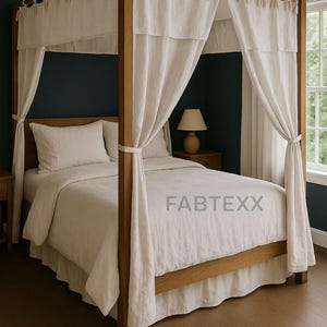 May include: A four-poster bed with a light-coloured wooden frame and draped, off-white fabric curtains. The bed is made up with matching bedding, including a duvet cover, pillows, and a bed skirt. The word "FABTEXX" is printed on the bed.