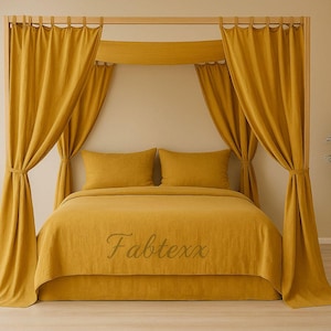 May include: A mustard yellow canopy bed with matching bedding and curtains. The bed has two pillows and a blanket. The curtains are draped around the bed frame. The word "Fabtexx" is embroidered on the blanket.
