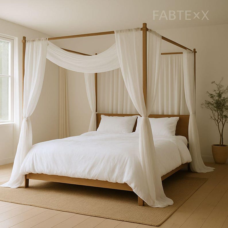 May include: A wooden four-poster bed with white bedding and sheer white curtains. The bed frame is a light brown color, and the curtains drape elegantly around the bed. The text "FABTEXX" is visible in the upper right corner.