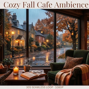 May include: A digital display titled Cozy Fall Cafe Ambience featuring a stone fireplace, a green armchair with a plaid blanket, and a wooden table with an open book, a steaming mug, and a candle, overlooking a rainy street with autumn trees.