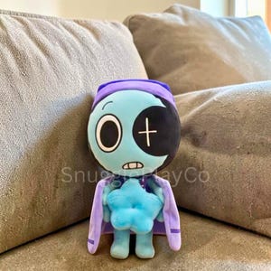 May include: A handmade wooden sign with the text "Welcome to our home" in a handwritten style. The sign is painted white with a dark stained frame. A small green plant is placed on the sign.