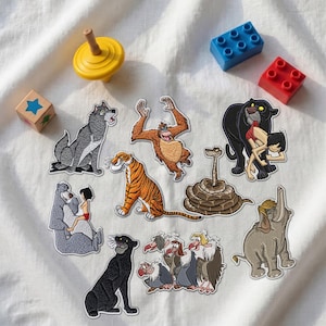 May include: A collection of embroidered fabric patches featuring characters from The Jungle Book, including a wolf, an orangutan, a tiger, a snake, a panther with a boy, a bear with a boy, a black panther, four vultures, and an elephant.
