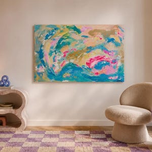 May include: A large rectangular abstract painting featuring swirling layers of teal, bright pink, gold, and soft peach paint. The artwork displays thick, textured brushstrokes and fluid, organic shapes that create a vibrant, multi-colored composition.