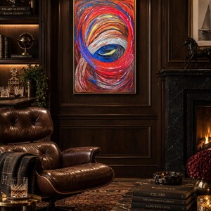 May include: A rectangular framed painting featuring thick, swirling impasto brushstrokes in vibrant shades of red, orange, blue, and white. The artwork displays a circular, vortex-like composition with layered textures and bold, expressive color blending.