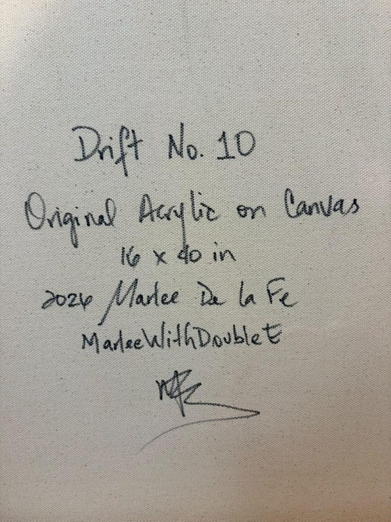 May include: A textured off-white canvas surface featuring handwritten black ink text that reads: Drift No. 10, Original Acrylic on Canvas, 16 x 40 in, 2024 Marlee De la Fe, MarleeWithDoubleE, and a stylized signature at the bottom.