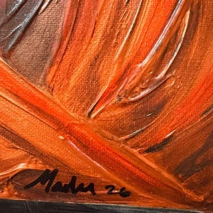 May include: An oil painting on canvas featuring thick, textured impasto brushstrokes in shades of vibrant orange, deep brown, and copper. The lower left corner displays a black handwritten signature that reads Mader 26 on the paint surface.