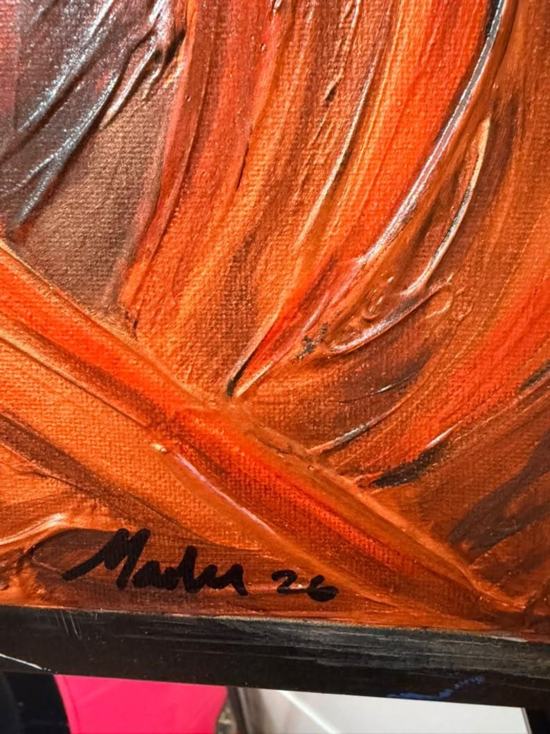 May include: An oil painting on canvas featuring thick, textured impasto brushstrokes in shades of vibrant orange, deep brown, and copper. The lower left corner displays a black handwritten signature that reads Mader 26 on the paint surface.