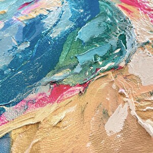 May include: An abstract painting on canvas featuring thick, textured impasto brushstrokes. The composition displays a vibrant color palette of deep navy blue, bright turquoise, metallic gold, hot pink, and creamy white paint layered across the surface.