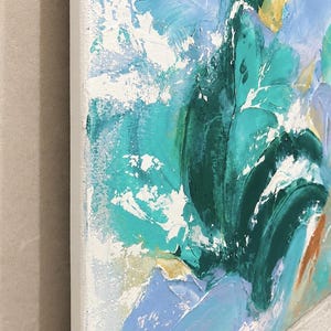 May include: An abstract painting on canvas featuring thick, textured impasto brushstrokes in shades of teal, forest green, light blue, and white. The composition displays layered paint application with visible depth and a prominent white edge.