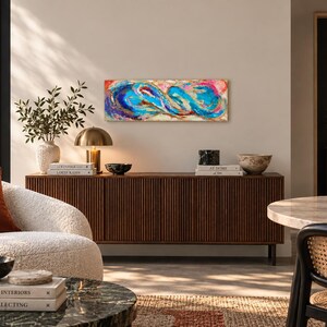 May include: A rectangular abstract painting featuring vibrant swirls of blue, turquoise, magenta, and gold paint. The composition displays fluid, interconnected shapes with textured layers and metallic accents, creating a dynamic visual flow across the canvas.