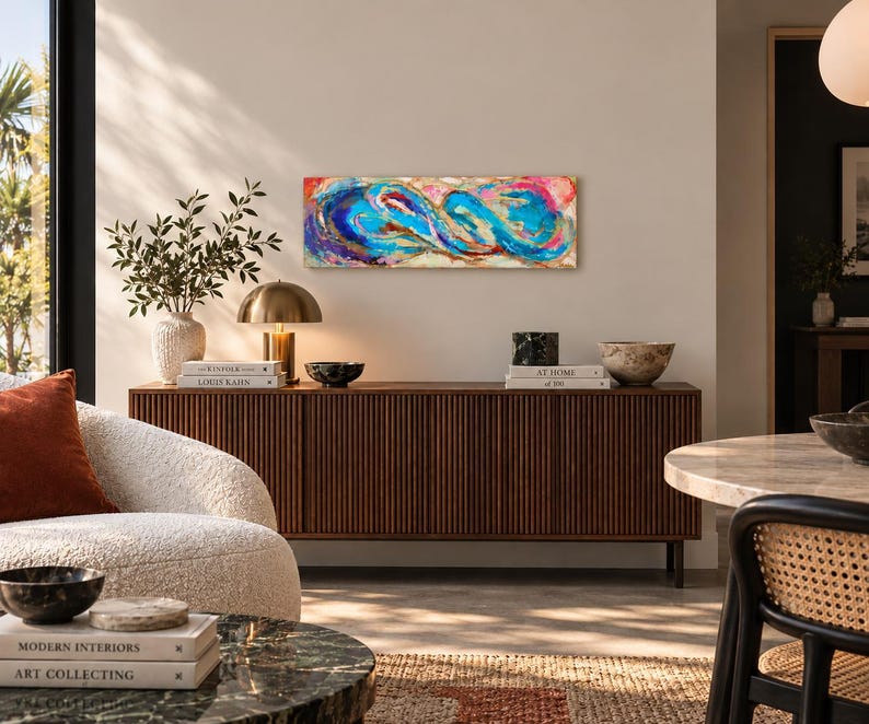 May include: A rectangular abstract painting featuring vibrant swirls of blue, turquoise, magenta, and gold paint. The composition displays fluid, interconnected shapes with textured layers and metallic accents, creating a dynamic visual flow across the canvas.
