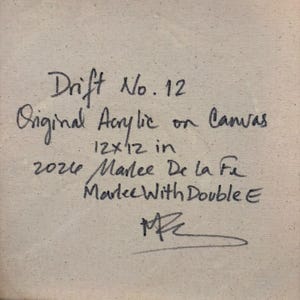 May include: A square canvas back featuring black handwritten text that reads: Drift No. 12, Original Acrylic on Canvas, 12x12 in, 2024, Marlee De la Fe, Marlee With Double E, and a signature. The canvas is mounted on a light wood frame.