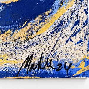 May include: An abstract painting on canvas featuring bold swirls of deep blue, bright yellow, and off-white paint. The texture is layered with splatters and thick brushstrokes. A black handwritten signature and the number 24 appear at the bottom.