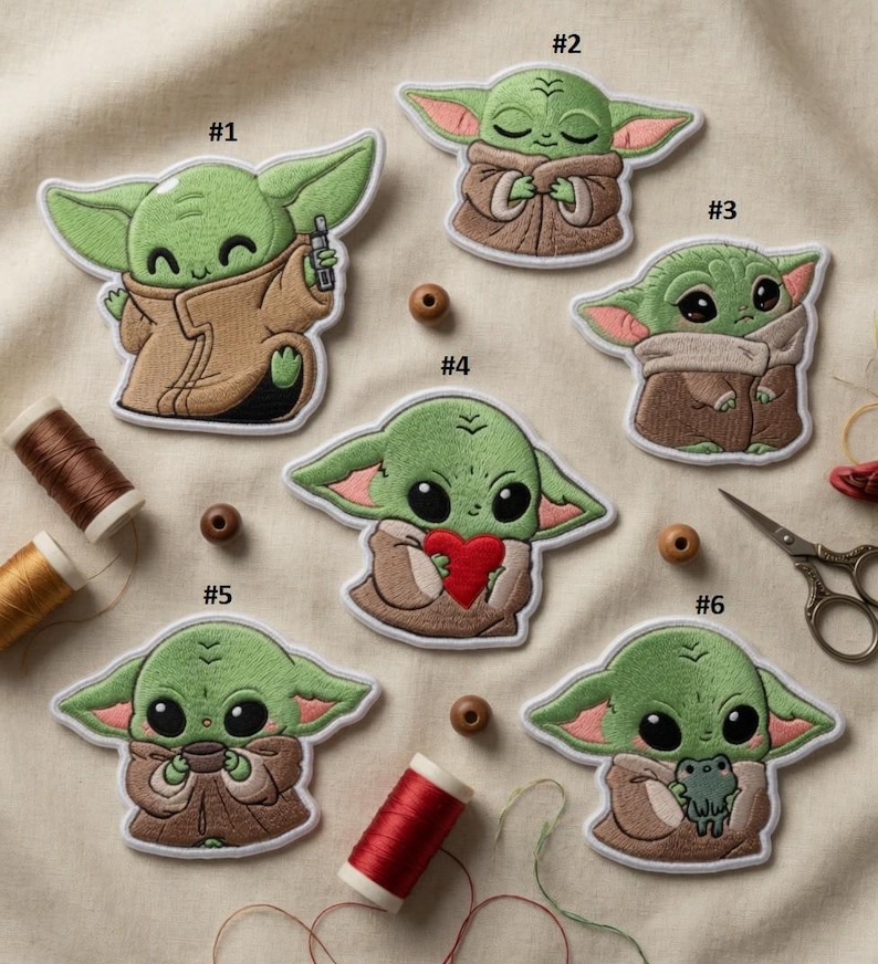 May include: A collection of six embroidered patches depicting a green alien character. Each patch shows the character in different poses, wearing a brown cloak. The patches are numbered and include a heart and a frog. Measurements are in cm.