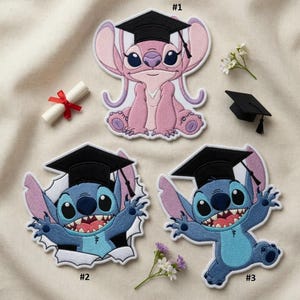 May include: Embroidered patches featuring characters from a popular animated film, wearing graduation caps. The patches are in shades of pink and blue, with black caps and white accents. A rolled diploma with a red ribbon is also present.