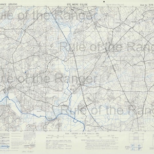 May include: A detailed map of France, labeled "FRANCE 125,000" and "STE MERE EGLISE". The map features a network of roads, fields, and waterways, with a blue river winding through the landscape. The scale is 25,000 or 0.98 inches to 1 mile.