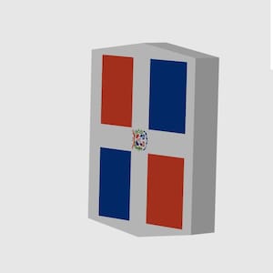 May include: A three-dimensional rectangular block featuring the flag of the Dominican Republic on its front face. The design consists of a white cross dividing the surface into four alternating red and blue rectangles, with a central coat of arms.